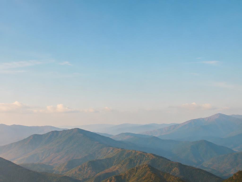 A distant mountain range under a wide sky, representative travel imagery